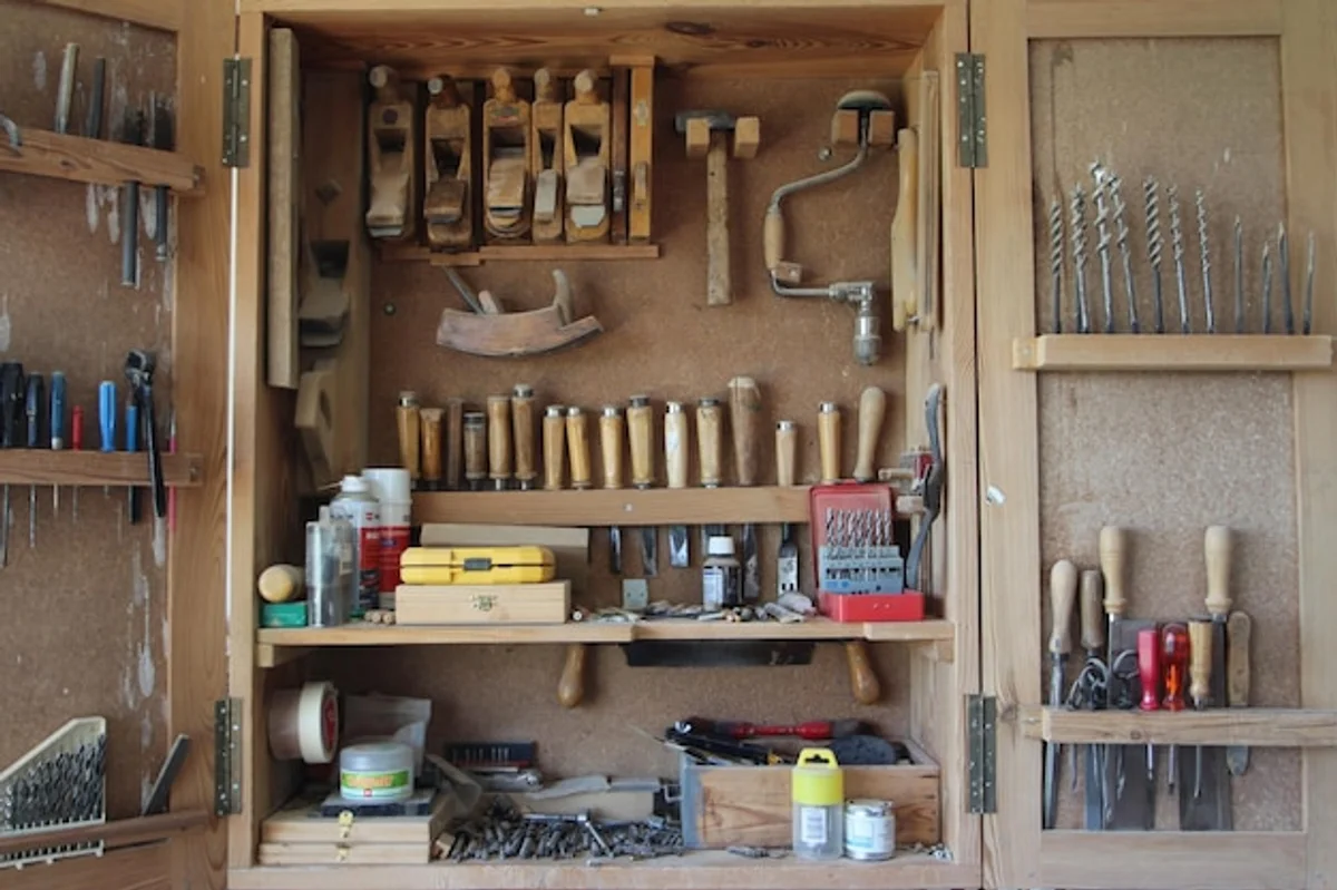 organized garden tools hanging neatly on a shed wall