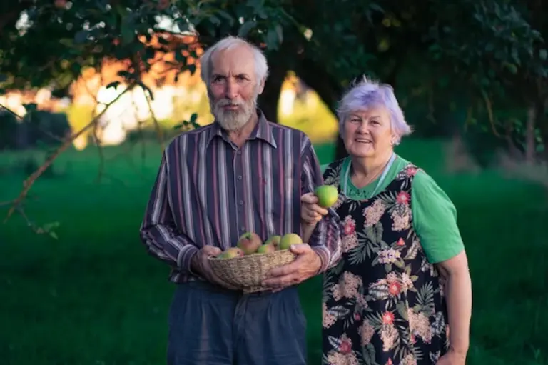 senior gardening enjoying fruit trees