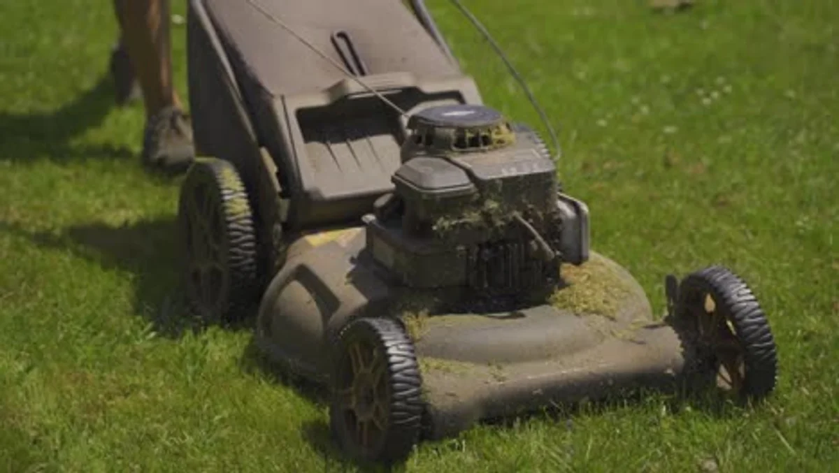 elderly person using robotic lawn mower garden