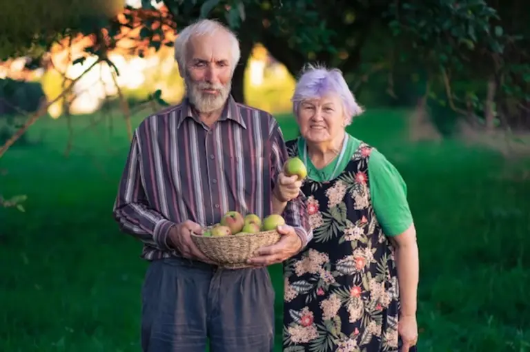 senior enjoying apple harvest in garden