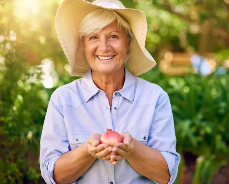 senior gardening fruit trees happy